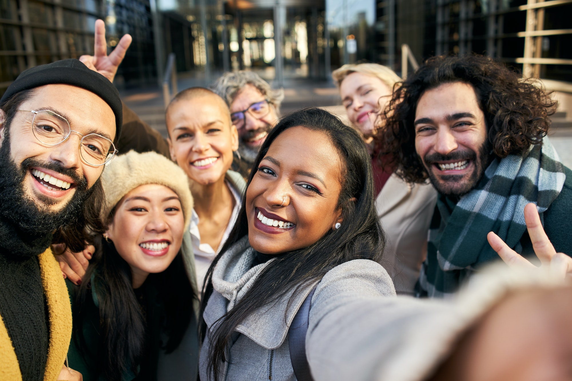 Selfie of a group of happy business people taking photo with a phone